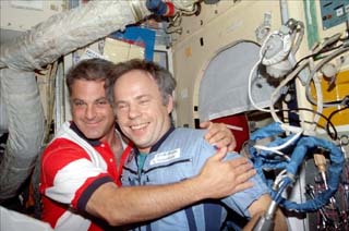 Wolf greets Mir-24 commander Anatoly Solovyev (right) with a hug. 